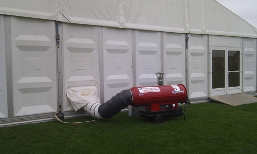 Red indirect diesel space heater hire unit, heating a large temporary building.