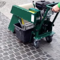 A Pergo Grout Cleaning Machine on hire and being used to clean an outdoor pavement